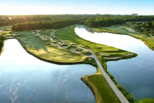 Dye Course aerial with golf cart path bridge over water to green