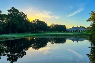 Founder Club at sunrise with fairway, lake and trees