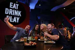 Friends taking selfie at Dave & Buster's