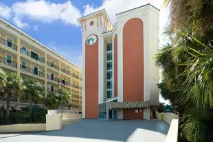 Palette Resort front entrance with palm trees