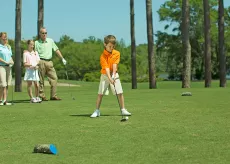 Family of four golfing