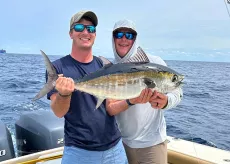 North Island Fishing Charters two buddies on a boat holding big fish