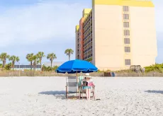 Surfside Beach Oceanfront Hotel lady reading on the beach