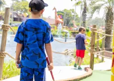 Kids playing mini golf at Jungle Safari course