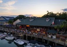 MarshWalk drone shot with the sunset over the restaurants