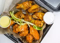 Wings CO wings with sauces in a to go box