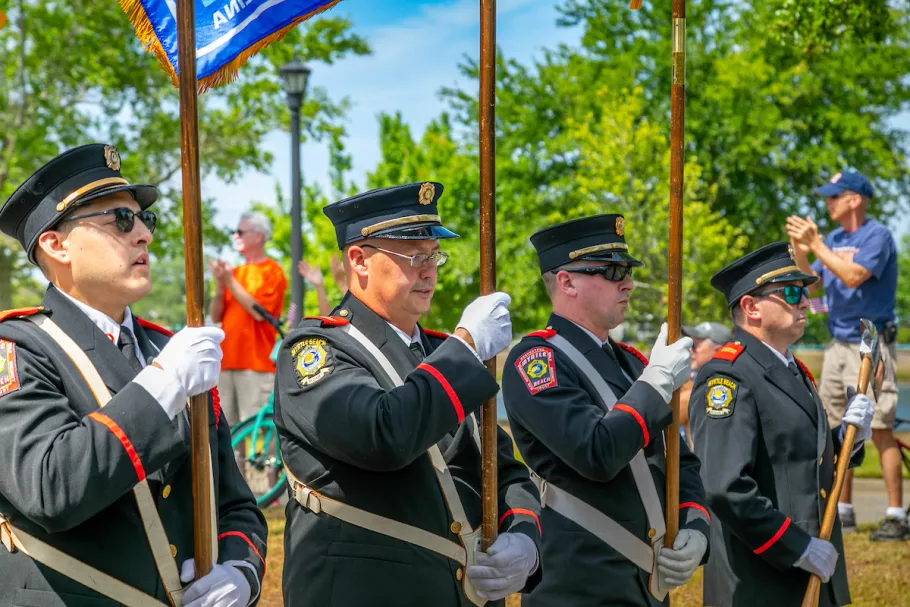Fire Dept Officers holding the flags at Memorial Day Parade
