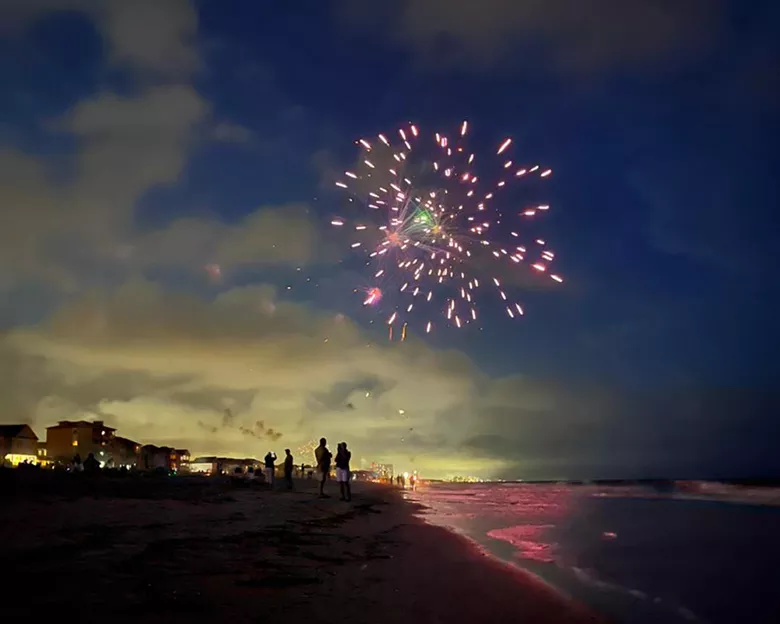 Fireworks at dusk over Surfside Beach on the beach
