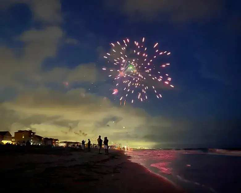 Fireworks at dusk over Surfside Beach on the beach