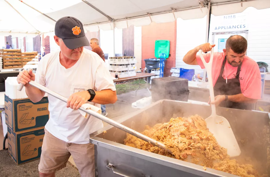 People cooking a big pot of chicken bog at Loris bog off