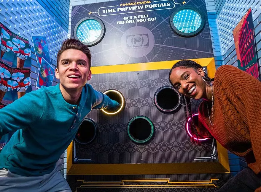 Escape Game Timeliner room two people with hands in tubes, what's in there?