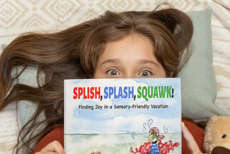 Young girl holding Splish, Splash, Squawk! book