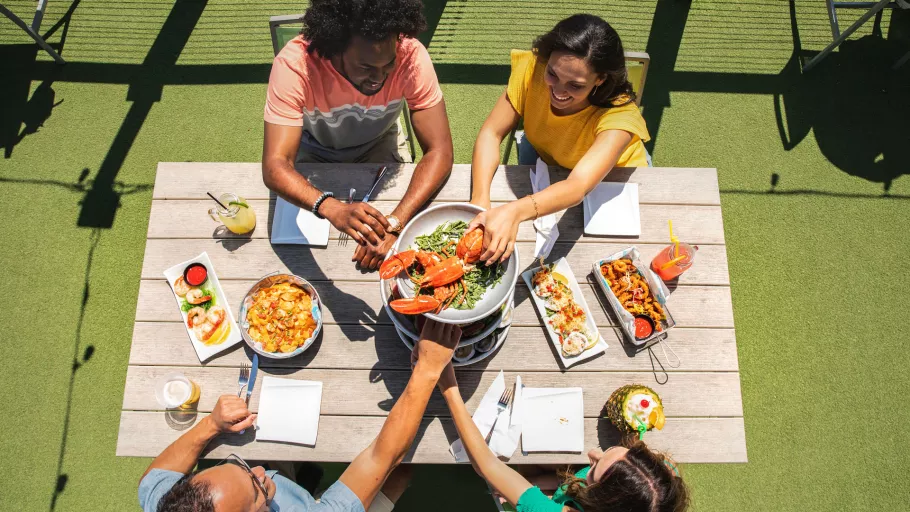 Friends enjoying a meal at Riptydz, an oceanfront restaurant.